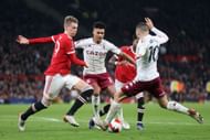 Fred and Scott McTominay tussling for the ball.